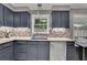 Detailed view of kitchen with stainless steel dishwasher, cabinets, and mosaic backsplash at 3202 Ivy Station Way, Duluth, GA 30096