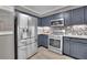 Charming kitchen with stainless steel appliances, dark cabinets, and ample counter space at 3202 Ivy Station Way, Duluth, GA 30096