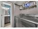 Convenient laundry room with washer, dryer, shelving, and storage space at 3202 Ivy Station Way, Duluth, GA 30096
