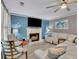 Inviting living room with fireplace, comfortable white sectional, and coastal-themed decor at 3202 Ivy Station Way, Duluth, GA 30096