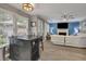 Open concept living area with eat-in island, fireplace, ceiling fan, and hardwood floors at 3202 Ivy Station Way, Duluth, GA 30096