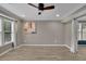 Open living room with hardwood floors, a ceiling fan, and windows with curtains at 3202 Ivy Station Way, Duluth, GA 30096
