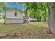 Backyard showing the home and deck with a large, mature tree in the foreground at 4492 Riverwood Cir, Decatur, GA 30035