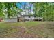 Wide shot of the backyard, showing a well-maintained lawn and a deck attached to the house at 4492 Riverwood Cir, Decatur, GA 30035
