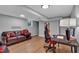Finished basement featuring a leather couch, wooden floors, and desk area at 4492 Riverwood Cir, Decatur, GA 30035