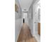 Hallway features hardwood flooring and white wainscoting leading to other rooms, offering a seamless transition and style at 4492 Riverwood Cir, Decatur, GA 30035