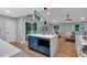 Open-concept kitchen with blue island, hardwood floors, stainless appliances, and access to the backyard at 4492 Riverwood Cir, Decatur, GA 30035