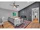 Living room with hardwood floors, fireplace, modern furnishings, and access to dining area at 4492 Riverwood Cir, Decatur, GA 30035