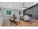 Open concept living room with hardwood floors, fireplace, large windows, dining area and modern furnishings at 4492 Riverwood Cir, Decatur, GA 30035