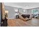 Spacious main bedroom with hardwood floors, a decorative bed, and a seating area, providing comfort and style at 4492 Riverwood Cir, Decatur, GA 30035