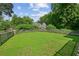 Large grassy backyard surrounded by a wooden fence at 55 Bowen Ave, Atlanta, GA 30315