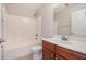 Simple bathroom with a combined tub and shower, toilet, and single sink vanity at 55 Bowen Ave, Atlanta, GA 30315