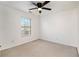 Simple bedroom with a ceiling fan, window, and neutral carpet at 55 Bowen Ave, Atlanta, GA 30315
