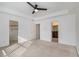 Neutral bedroom with a closet and bathroom featuring tray ceilings, ample natural light, and comfortable carpet at 55 Bowen Ave, Atlanta, GA 30315