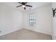 Carpeted bedroom features a ceiling fan, window, and white walls at 55 Bowen Ave, Atlanta, GA 30315