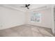 Carpeted bedroom with tray ceilings, a ceiling fan and natural light coming from the window at 55 Bowen Ave, Atlanta, GA 30315