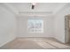 Bright and airy bedroom featuring carpeted floors, tray ceilings and a large window at 55 Bowen Ave, Atlanta, GA 30315