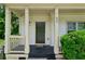 Inviting covered front porch with columns and dark front door at 55 Bowen Ave, Atlanta, GA 30315