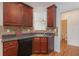This kitchen has a breakfast bar, tile backsplash, and wood cabinets with laminate countertops at 55 Bowen Ave, Atlanta, GA 30315