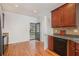 Kitchen featuring laminate countertops, a black dishwasher, wood cabinets, and hardwood floors at 55 Bowen Ave, Atlanta, GA 30315
