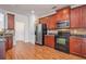 Kitchen space featuring stainless steel appliances, tile backsplash, and dark wood cabinetry at 55 Bowen Ave, Atlanta, GA 30315