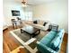 Cozy living room with hardwood floors, a comfortable seating arrangement, and a sunny window at 55 Bowen Ave, Atlanta, GA 30315