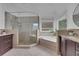 Elegant bathroom with a glass enclosed shower and garden tub, plus dual sink vanities at 13 Highland Park Ne Ln, Atlanta, GA 30306
