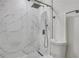 Modern bathroom featuring a sleek glass shower with white marble tile and updated fixtures at 13 Highland Park Ne Ln, Atlanta, GA 30306