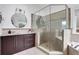 Updated bathroom with a tile-surround glass shower, dual vanities, and natural light at 13 Highland Park Ne Ln, Atlanta, GA 30306