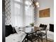 Cozy dining area featuring a window seat, modern light fixture, and dark accent furniture at 13 Highland Park Ne Ln, Atlanta, GA 30306