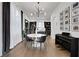 Well-lit dining room showcasing hardwood floors, modern lighting, gallery wall, and a peek into the office at 13 Highland Park Ne Ln, Atlanta, GA 30306