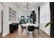 Bright dining room with modern chandelier, piano, hardwood floors, and a gallery wall at 13 Highland Park Ne Ln, Atlanta, GA 30306