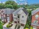 Beautiful home exterior featuring stone accents, a two-car garage, and a view of the Atlanta skyline at 13 Highland Park Ne Ln, Atlanta, GA 30306