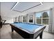 Spacious game room features a billiard table, a wall mounted TV, and bright natural light at 13 Highland Park Ne Ln, Atlanta, GA 30306