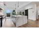 Bright, modern kitchen with a large marble island, stainless steel appliances, and arched windows offering scenic views at 13 Highland Park Ne Ln, Atlanta, GA 30306
