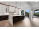 Spacious kitchen with a large island with bar seating, white cabinetry, and large windows with a beautiful outdoor view at 13 Highland Park Ne Ln, Atlanta, GA 30306