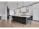 Open concept kitchen featuring a large island with seating, white cabinets, and hardwood floors at 13 Highland Park Ne Ln, Atlanta, GA 30306