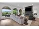 Open-concept living room with a fireplace, large windows, and access to an outdoor patio at 13 Highland Park Ne Ln, Atlanta, GA 30306