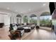 Bright living room with hardwood floors, stylish seating, and views of the city skyline at 13 Highland Park Ne Ln, Atlanta, GA 30306