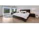 Inviting main bedroom with ample natural light, a cozy seating area, and stylish hardwood floors at 13 Highland Park Ne Ln, Atlanta, GA 30306