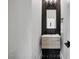 Stylish powder room featuring black honeycomb tile, a modern vanity, and sleek fixtures at 13 Highland Park Ne Ln, Atlanta, GA 30306