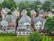 Aerial view displaying multiple back patios surrounded by mature trees in a manicured lawn setting at 13 Highland Park Ne Ln, Atlanta, GA 30306