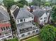 Rear aerial view showing a back patio with comfortable seating, and a lush green yard in a residential area at 13 Highland Park Ne Ln, Atlanta, GA 30306