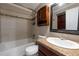 Bathroom featuring a sink, vanity, toilet, and shower with tile surround at 134 Timber Creek Sw Ln, Marietta, GA 30060