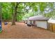 Expansive backyard featuring a patio area, fire pit, and lush greenery at 2038 Summertown Dr, Norcross, GA 30071