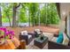 Backyard with patio set, surrounded by mature trees and landscaping at 2038 Summertown Dr, Norcross, GA 30071