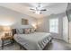 Spacious bedroom features a ceiling fan, bedside lamps, and a view of the window at 2038 Summertown Dr, Norcross, GA 30071