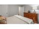 Bedroom with wooden dresser, soft carpet, and neutral bedding at 2038 Summertown Dr, Norcross, GA 30071