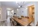 Open concept dining area with rustic wood table, contemporary lighting and kitchen access at 2038 Summertown Dr, Norcross, GA 30071