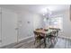 Stylish dining room with modern chandelier, wood table, and sleek flooring at 2038 Summertown Dr, Norcross, GA 30071